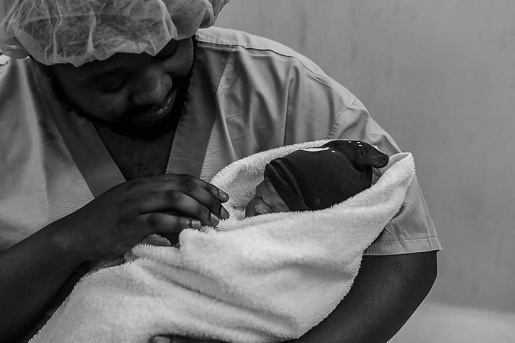 Man holding newborn